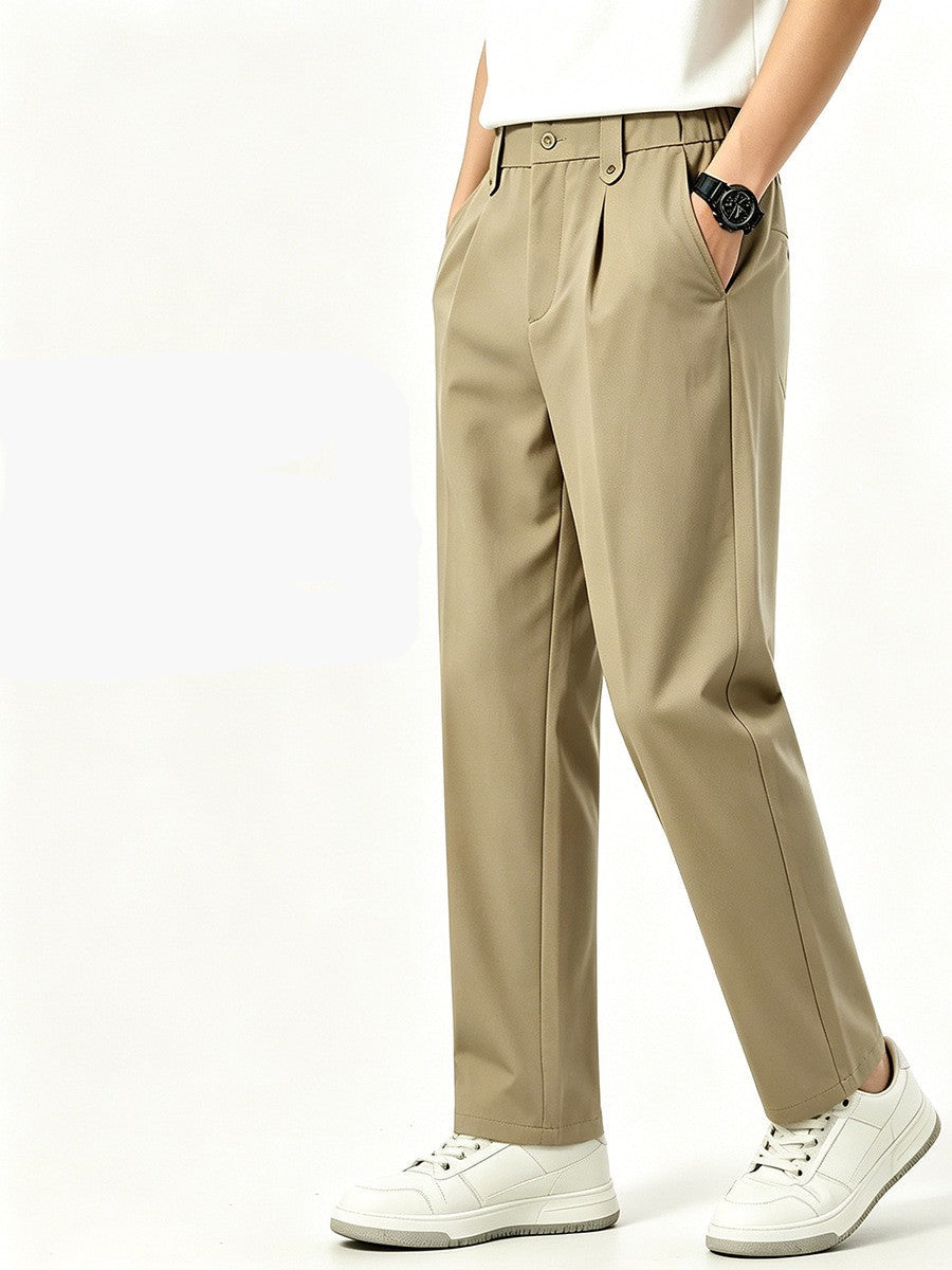 Men's beige tapered pants styled with a white T-shirt and sneakers